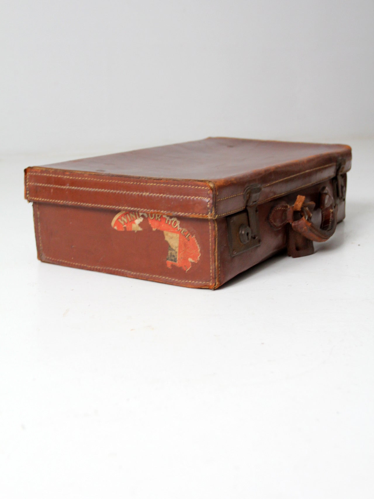 antique leather suitcase with travel stickers