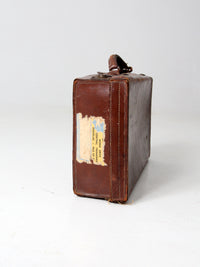 antique leather suitcase with travel stickers