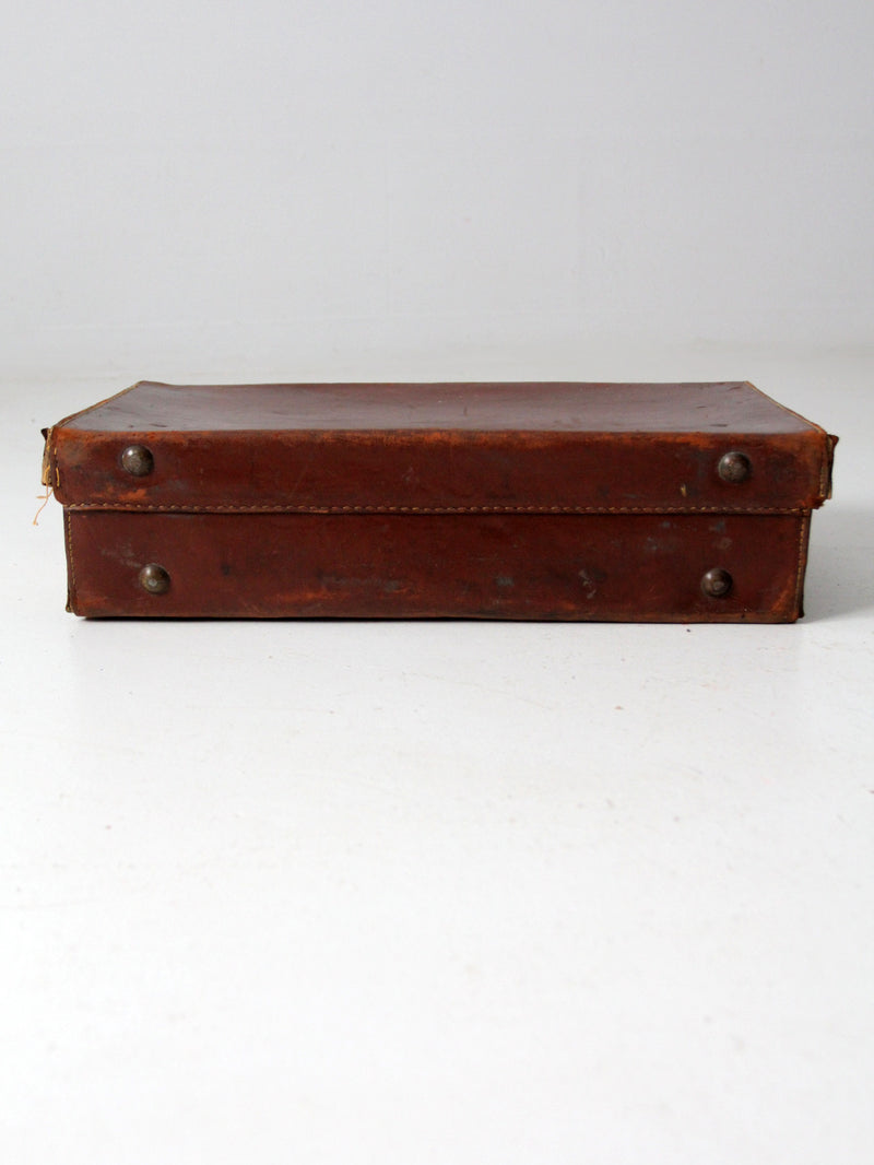 antique leather suitcase with travel stickers