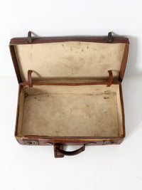 antique leather suitcase with travel stickers