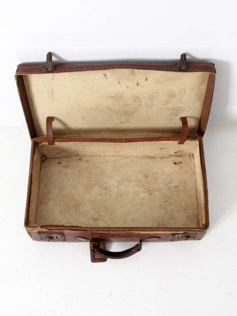 antique leather suitcase with travel stickers