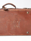 antique leather suitcase with travel stickers