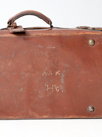 antique leather suitcase with travel stickers