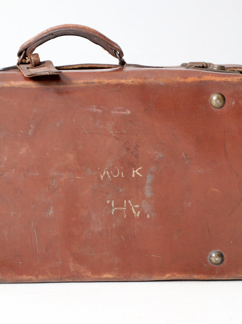 antique leather suitcase with travel stickers