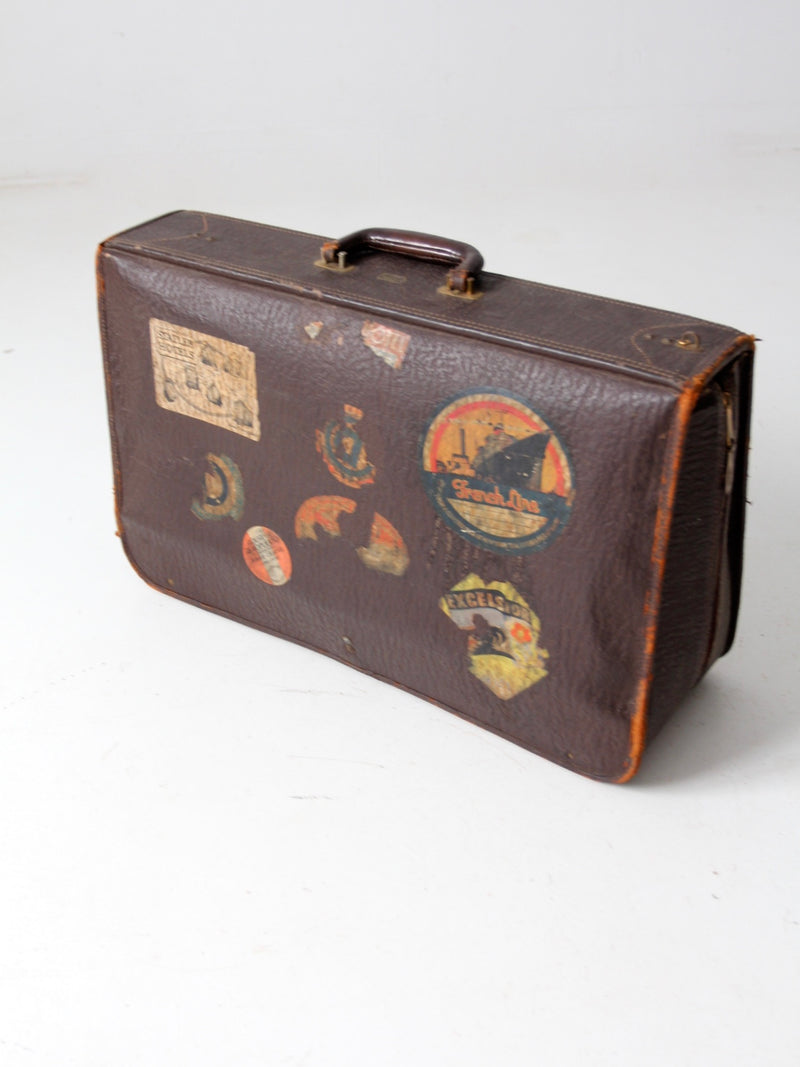 vintage leather suitcase with travel stickers