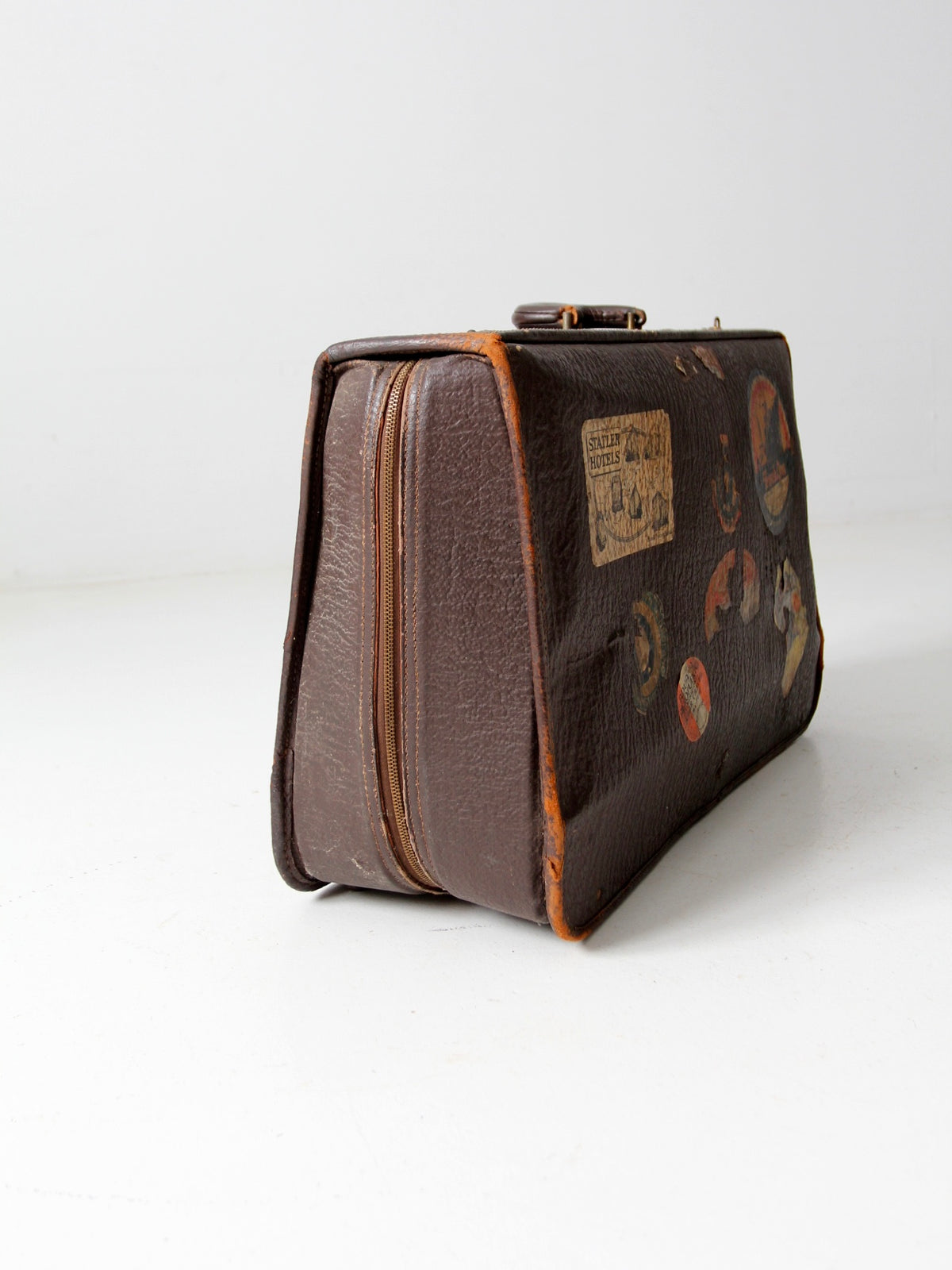 vintage leather suitcase with travel stickers