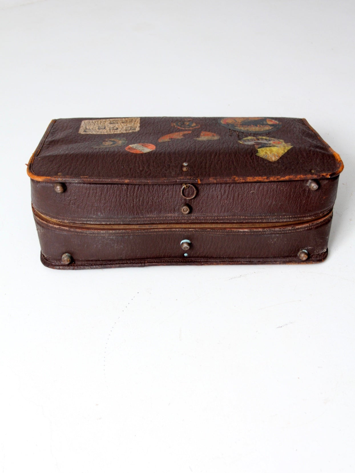 vintage leather suitcase with travel stickers