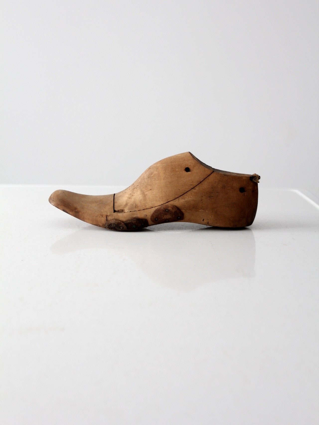 antique cobbler's shoe form with leather patching