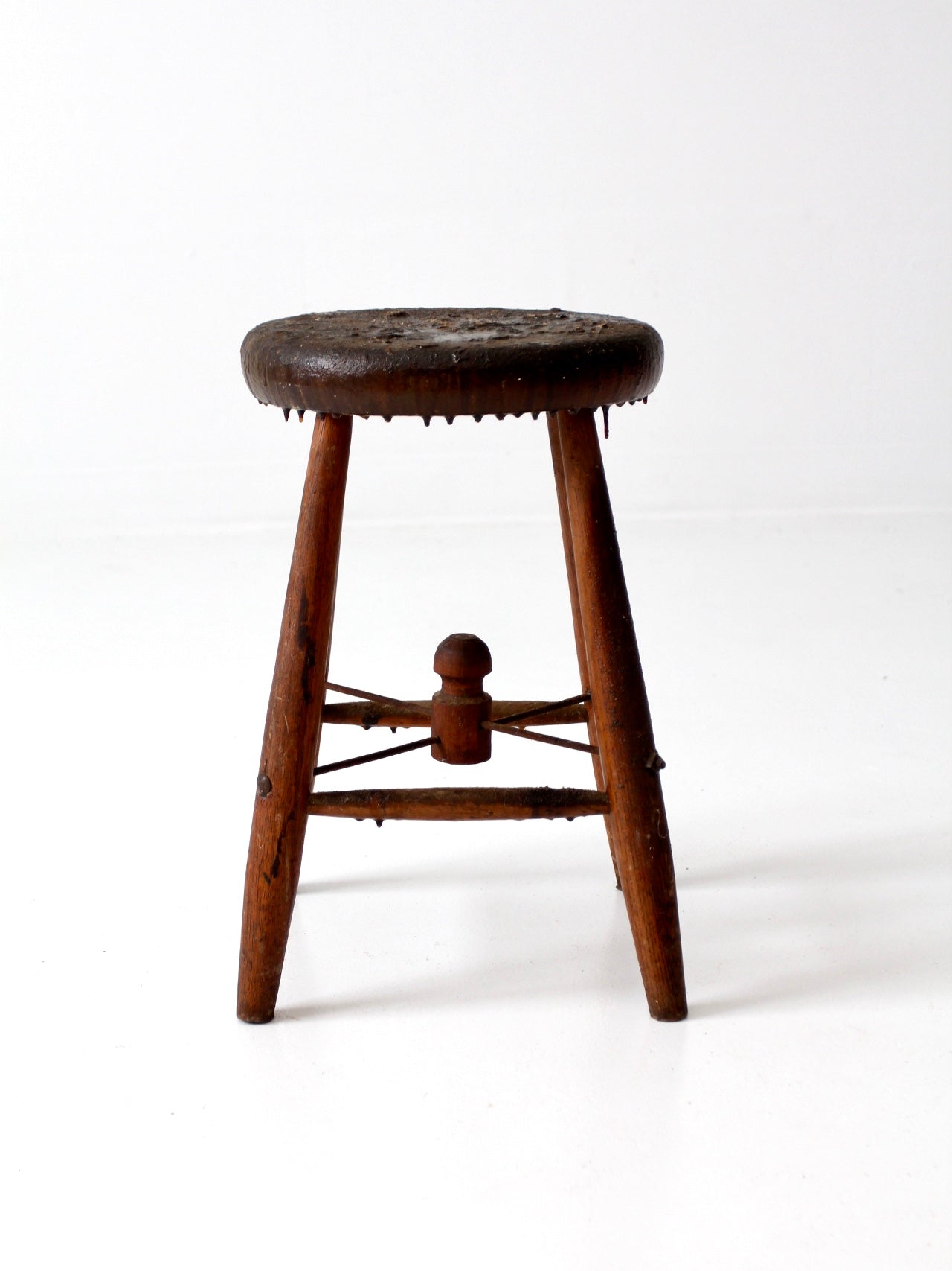 antique wooden stool with wire stretcher