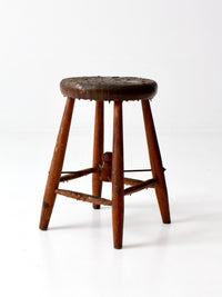 antique wooden stool with wire stretcher