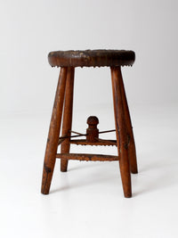 antique wooden stool with wire stretcher