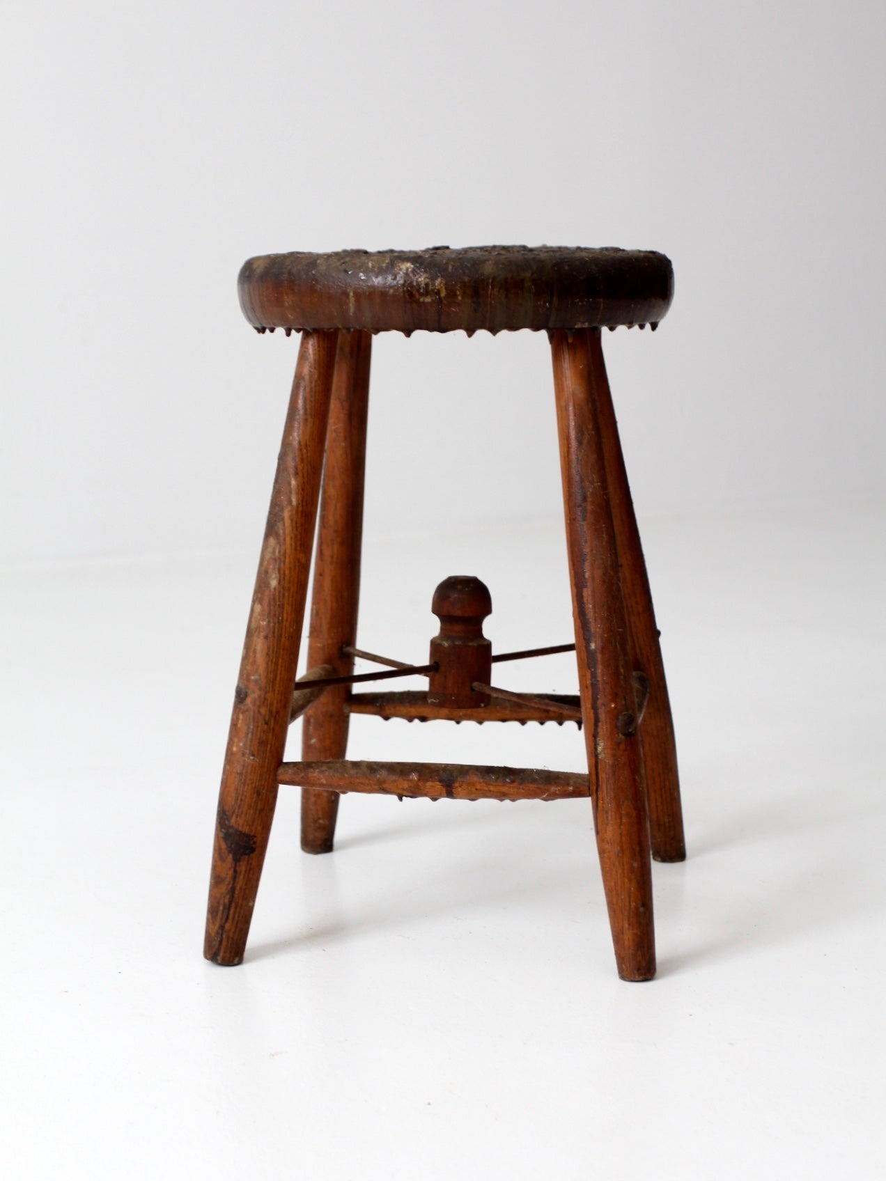 antique wooden stool with wire stretcher