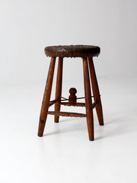 antique wooden stool with wire stretcher