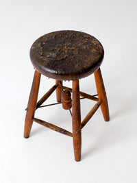 antique wooden stool with wire stretcher