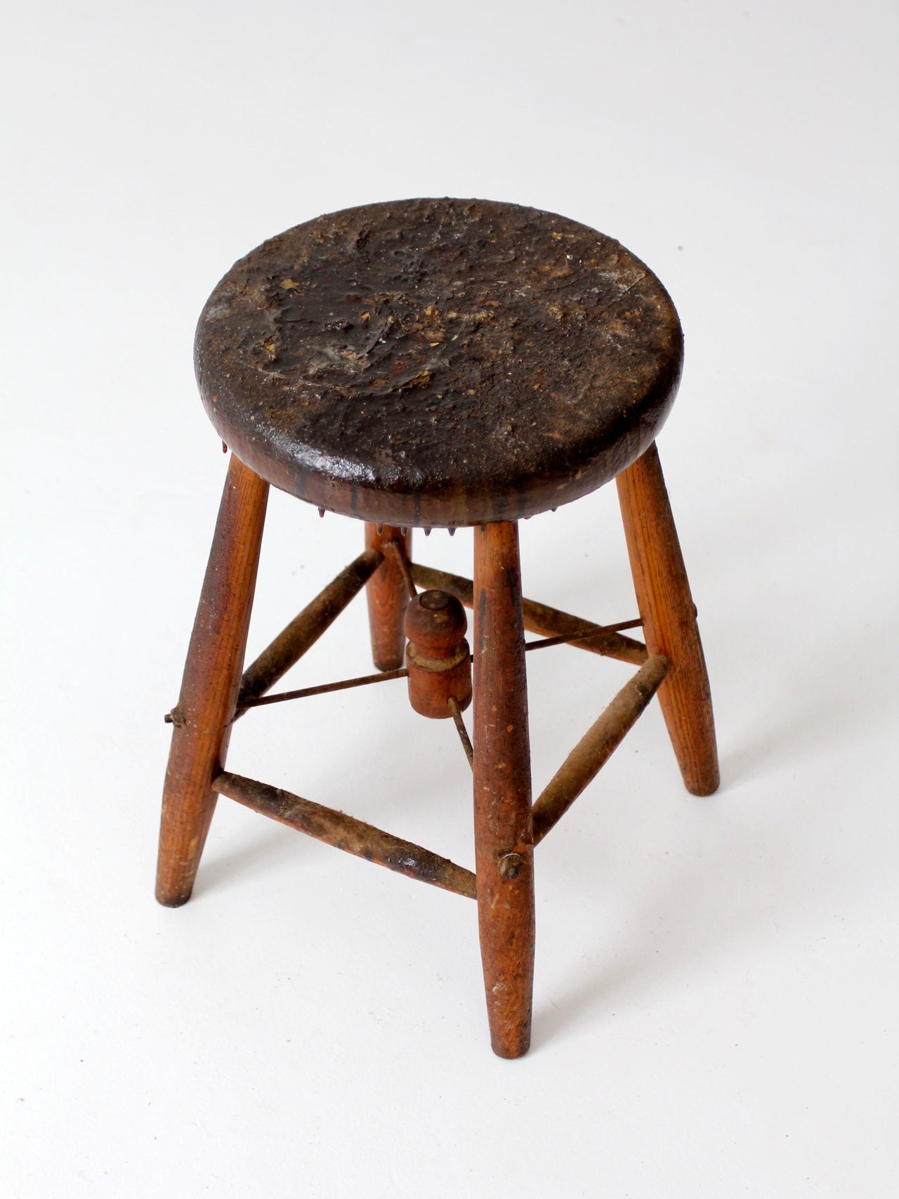 antique wooden stool with wire stretcher