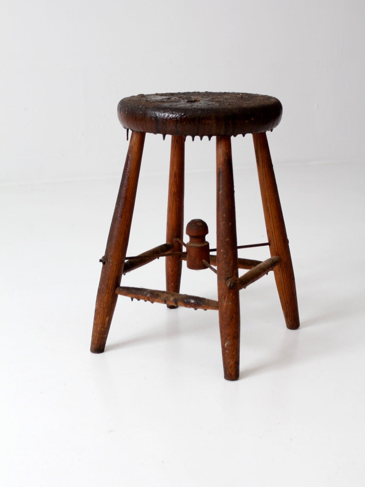 antique wooden stool with wire stretcher