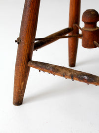 antique wooden stool with wire stretcher