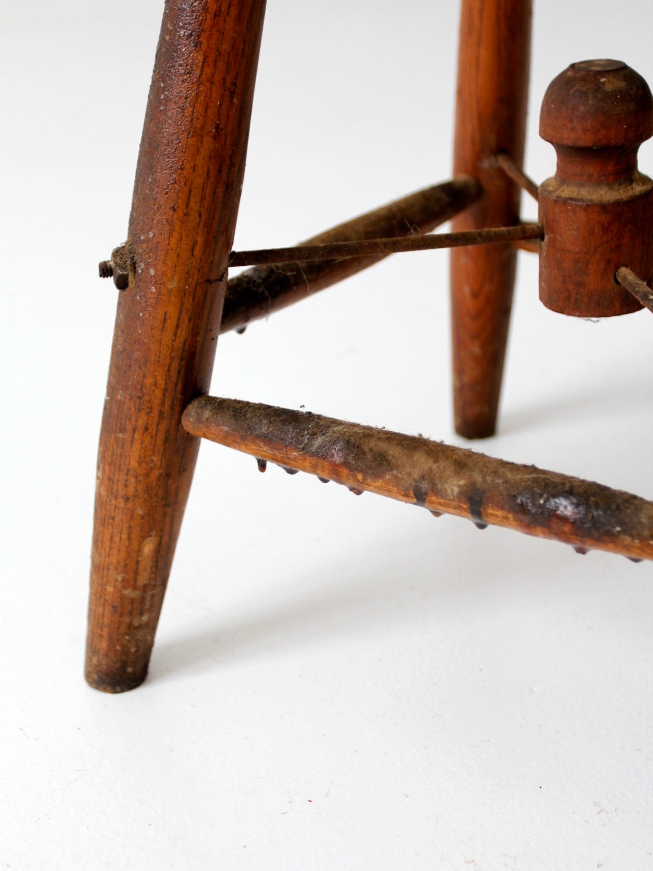 antique wooden stool with wire stretcher