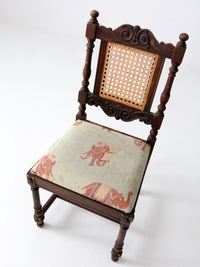 carved wood chair with cane back