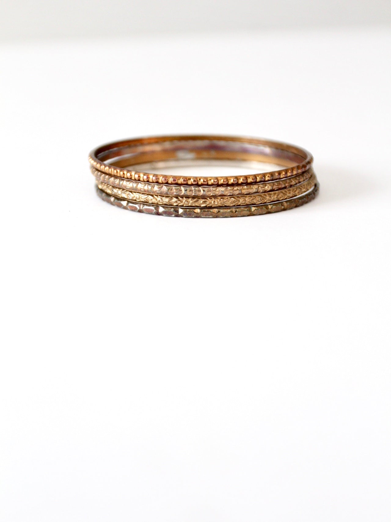 vintage thin metal stacking bangles, set of 4