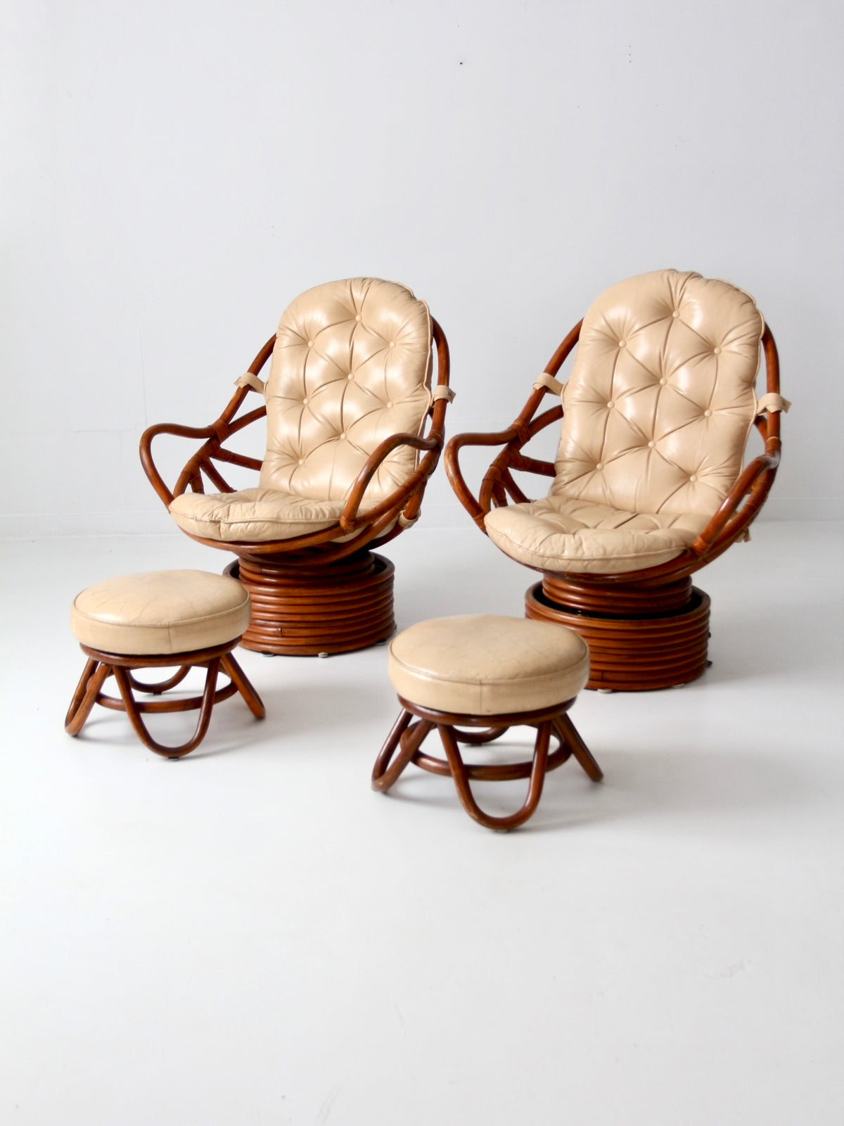 mid-century rattan swivel chairs with ottomans