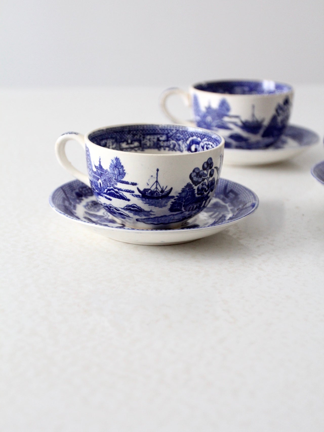 vintage blue willow tea cups with saucers set